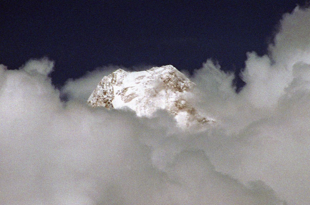 08 Gasherbrum IV Summit Pokes Out Of Clouds On Trek From Khoburtse To Goro II Up ahead, I kept my eye out for Gasherbrum IV, which poked its summit out of the clouds for a minute as I trekked from Khoburtse to Goro II.